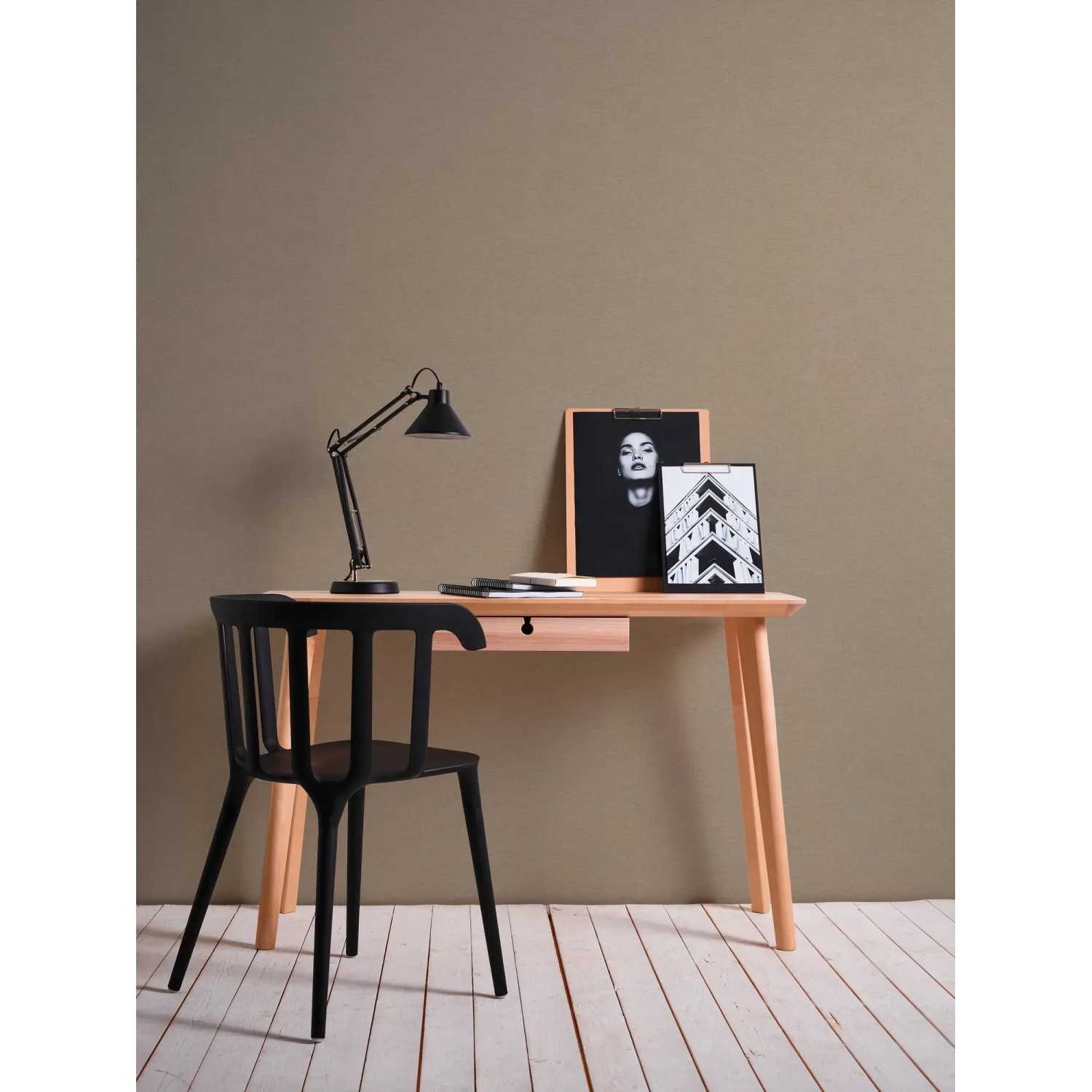 Beige-braune Vliestapete mit leichter Struktur an einer Wand hinter einem Schreibtisch.