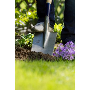 LUX Gärtnerspaten Geestemünder Form im Einsatz: Person tritt auf Spatenblatt im Garten.