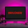 Briloner LED Streifen Flexband, 5 m, mehrfarbig, hinter einem Monitor angebracht.