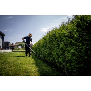 Mann trimmt Hecke mit Akku-Rasentrimmer Metabo RTD 18 LTX BL 30. Leichter Akku-Trimmer für Gartenarbeiten.