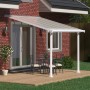 Weiße Palram Canopia Olympia Terrassenüberdachung 3x3.1 mit klarem Dach und Sitzgruppe auf Terrasse.
