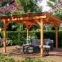 Heller Skan Holz Gartenpavillon Marseille aus lasierter Eiche mit transparentem Dach, schützt Sitzbereich im Garten.