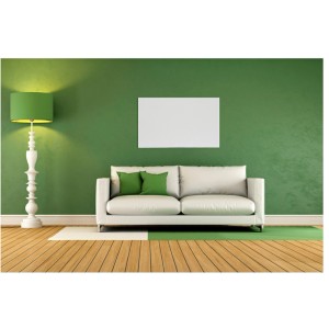 Vitalheizung Infrarot-Heizpaneel Premium L (850 W) an grüner Wand über Sofa.