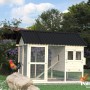 Palmako Hühnerstall Chick 6,7 m² mit Auslauf und Legekasten im Garten.