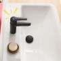 Schwarze Grohe QuickFix Waschtischarmatur Start S auf einem weißen Waschbecken.