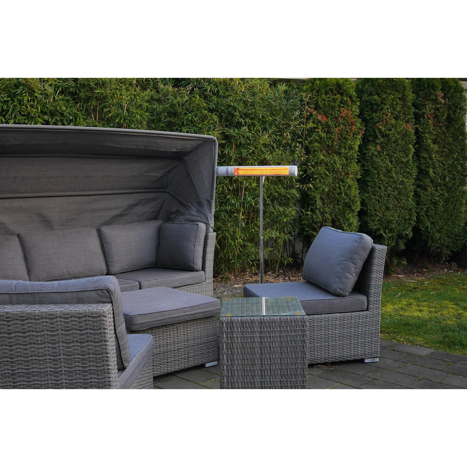 VASNER SlimLine X20 Infrarot-Heizstrahler (2000W, Silber) neben grauer Lounge-Garnitur im Garten.