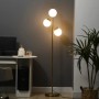Goldene Stehleuchte mit drei leuchtenden Glaskugeln, modernem Metallgestell, für Innenleuchten.