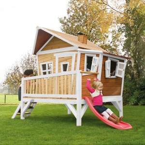 Axi Emma Spielhaus mit Rutsche: Braun-weißes Holzhaus mit roter Rutsche für Kinder im Garten.