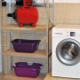 Einhell Hauswasserwerk GC-WW 6538 Set mit Pumpe, Saugschlauch und Zubehör im Regal.