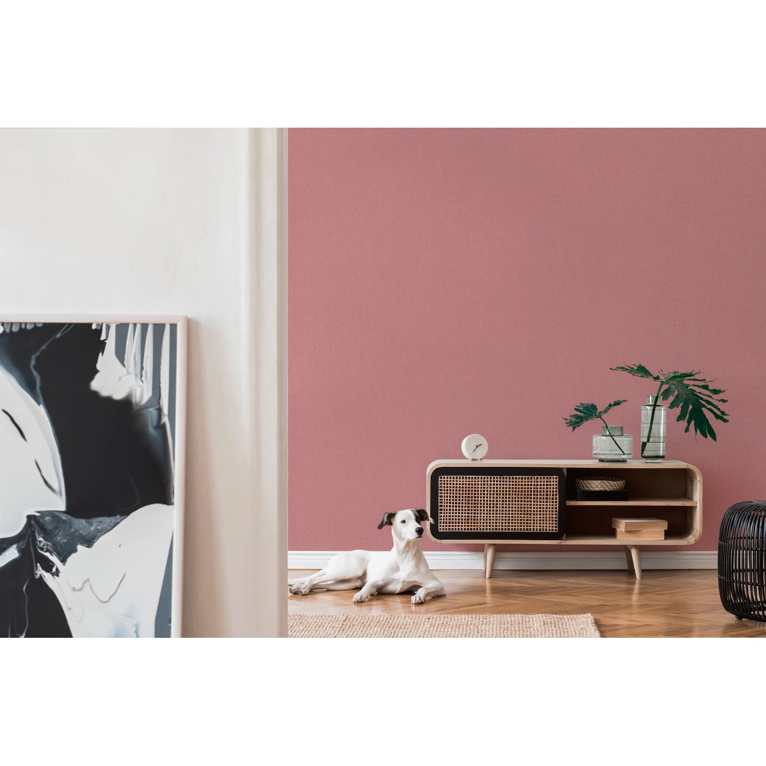 A.S. Création Vliestapete Uni Rosa an Wand im Wohnraum mit Hund und Kommode.
