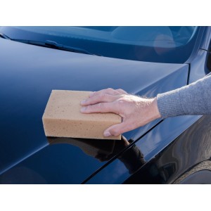 Hand reinigt Auto mit eckigem CMI Autowaschschwamm. Autopflege für schonende Reinigung.