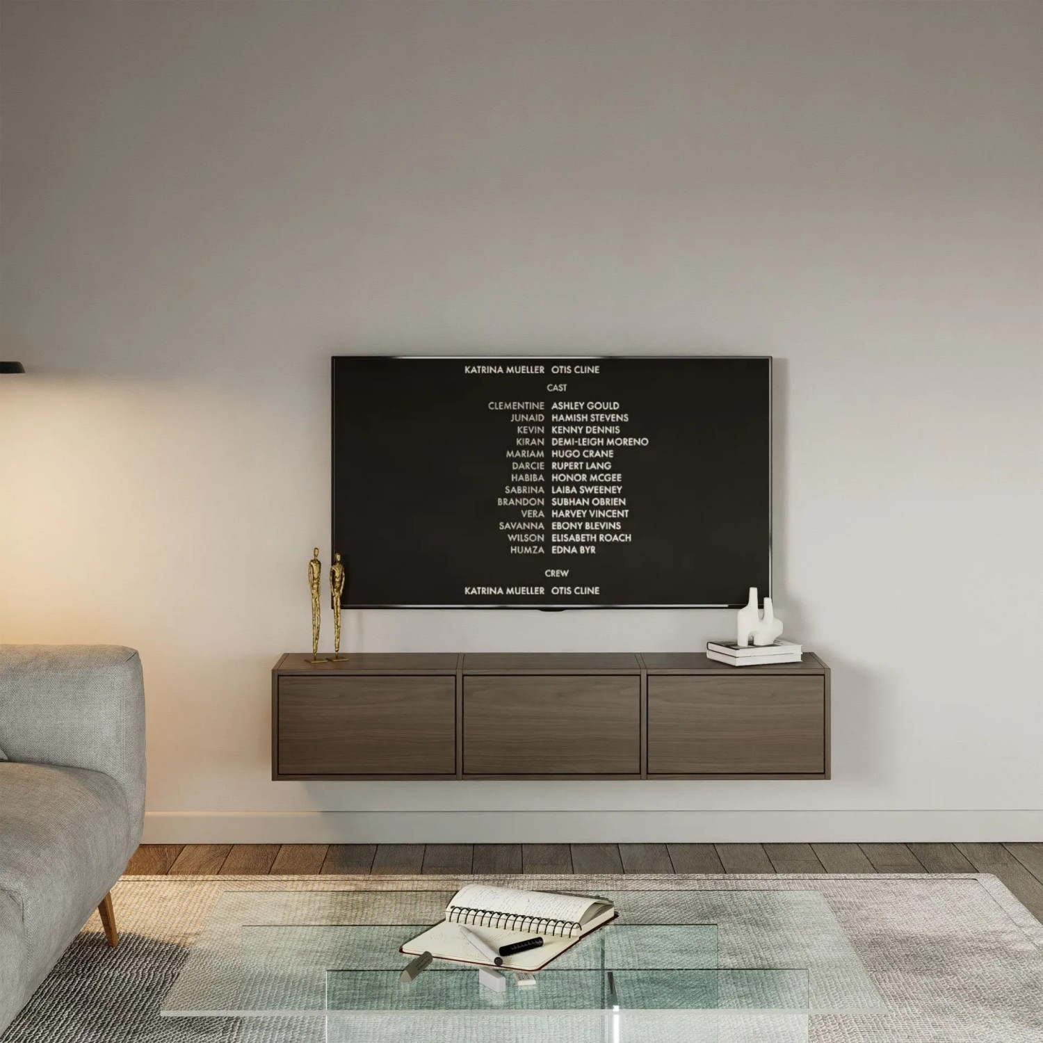 Selsey TV-Hängeboard Framme 150 cm in Walnuss-Holzoptik, wandmontiert mit 3 grifflosen Klappen unter einem TV im Wohnzimmer.