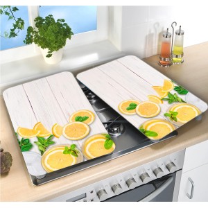 Wenko Herdabdeckplatten Zitronen, 2er Set, Mehrfarbig. Glasabdeckungen mit Zitronen-Motiv auf einem Herd.