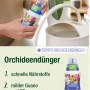 Frau dosiert Compo Orchideendünger 250ml für Orchideen in weißem Topf.