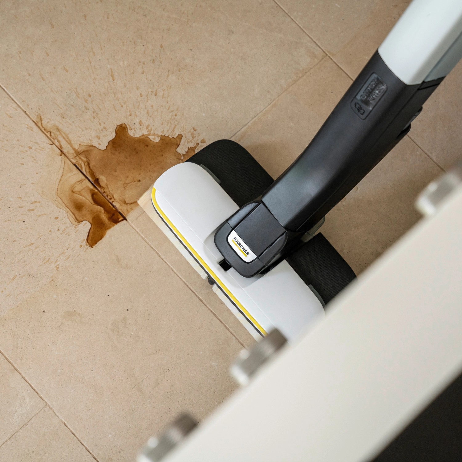 Kärcher Akku-Hartbodenreiniger FC 4-4 in Weiß-Schwarz bei der Reinigung von verschmutzten Fliesen.