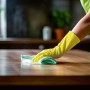 Gelbe Mehrweghandschuhe Größe S beim Reinigen einer Oberfläche. Haushaltshandschuhe schützen die Hände.