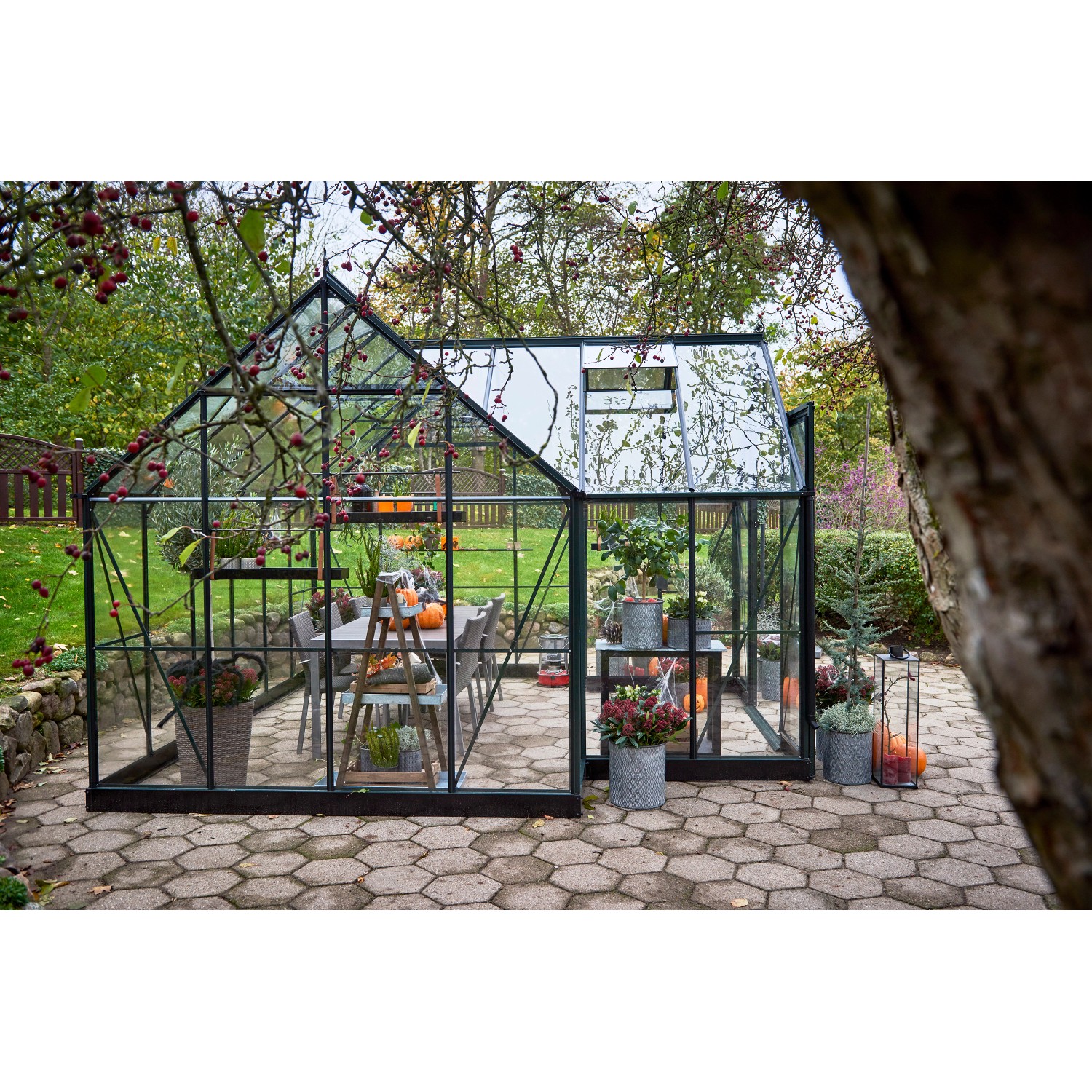 Halls Gewächshaus Garden Room, grün, 12,9 m², mit Esstisch und Pflanzen.