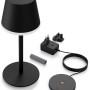 Schwarze Philips Hue Go Tischleuchte mit Ladestation und Zubehör.
