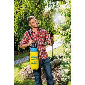 Mann nutzt Gloria AutoPump Set Drucksprühgerät zur Gartenarbeit. Gelber Behälter mit blauem Deckel.