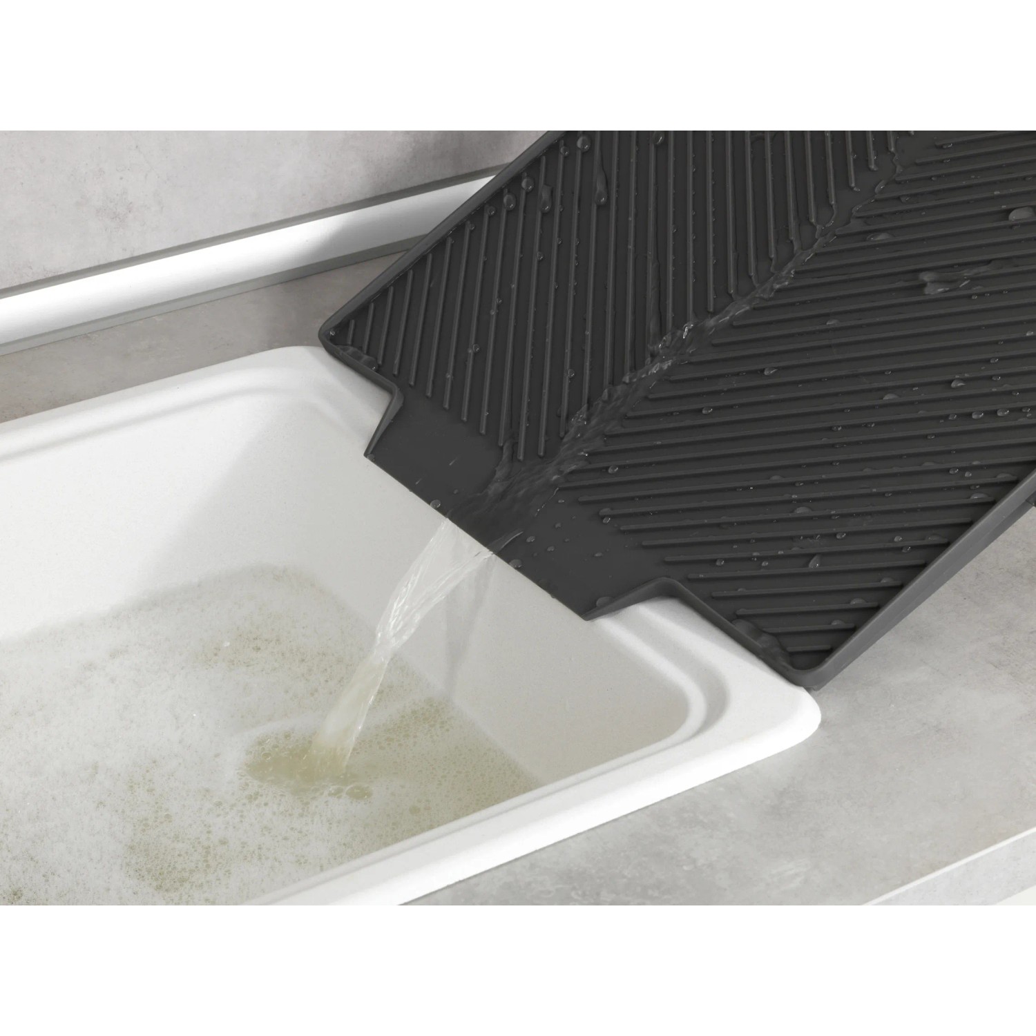 Graue Wenko Abtropfmatte Nelia Maxi (40x35cm) über Spülbecken mit Wasserablauf.