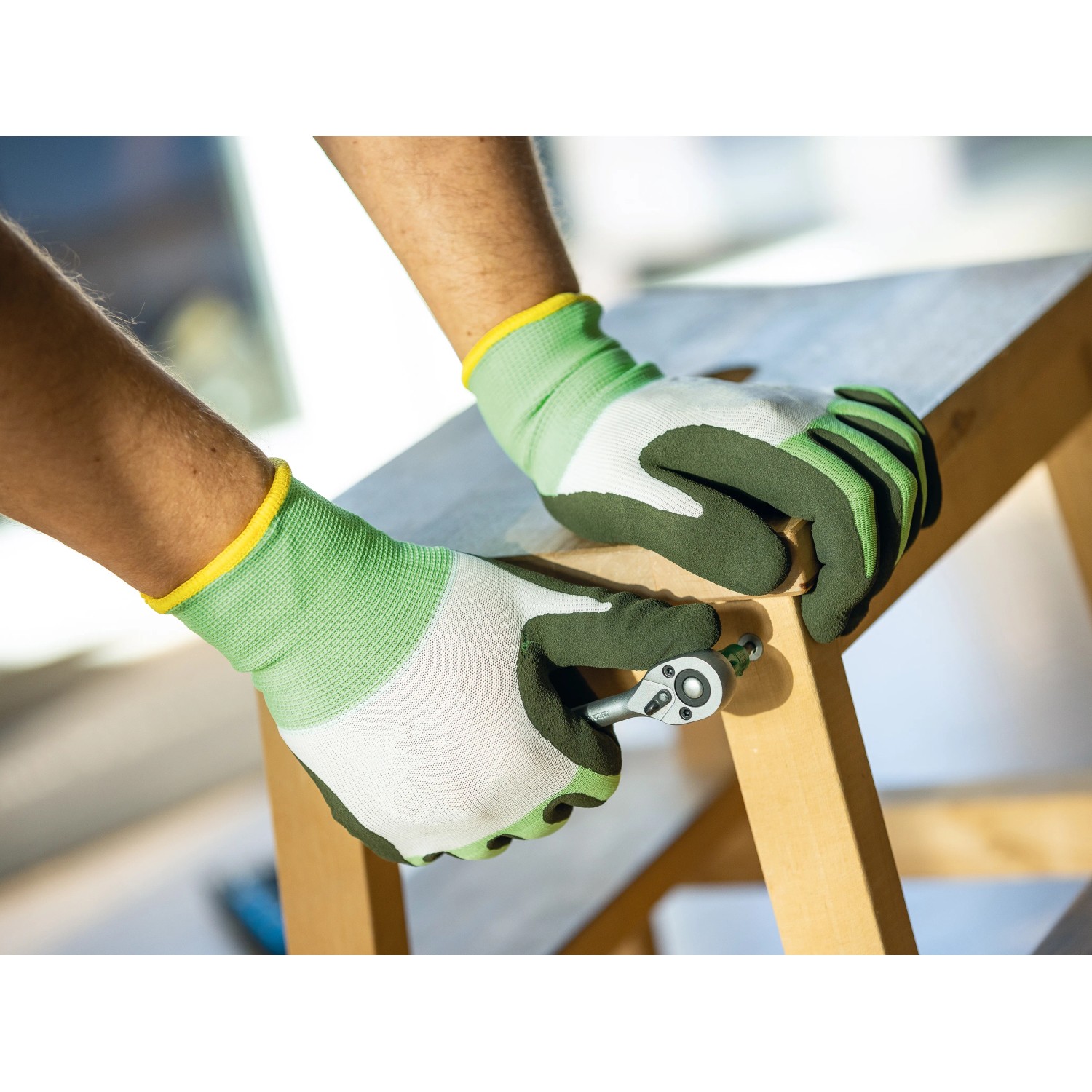 Hände mit LUX Arbeitshandschuhen Eco Gr. 9 bei Montagearbeiten mit Werkzeug.