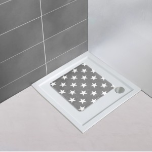 Graue Wenko Duscheinlage Stella 54x54 cm mit weißen Sternen in einer Dusche.