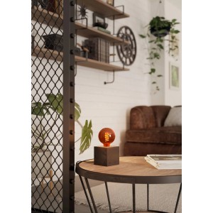 Eglo E27 LED Leuchtmittel in Globeform, 4W, mit warmem Licht auf Tischleuchte im Wohnzimmer.