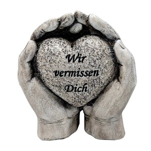 Grabdekoration: Hände halten Herz mit Inschrift "Wir vermissen Dich".