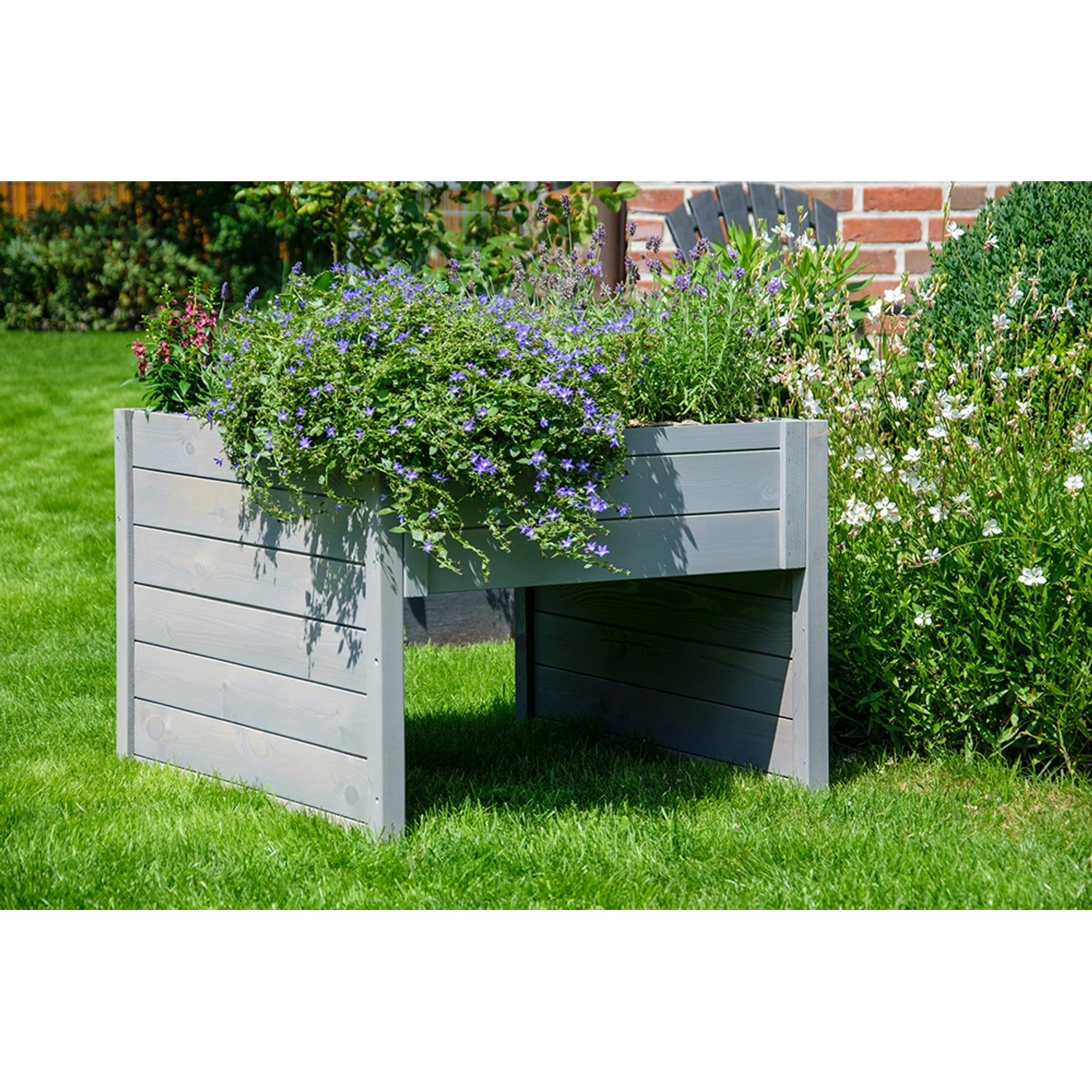 Graue Dobar Mährobotergarage mit Pflanzkasten, bepflanzt mit Blumen.