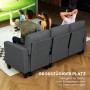 Dunkelgraues HOMCOM Ecksofa mit Schlaffunktion und Chaiselongue, auf dem Gäste entspannt fernsehen.
