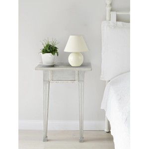 Beige Keramik Tischleuchte mit Stoffschirm auf Nachttisch. Design-Tischlampe für Schlafzimmer.