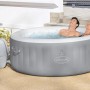 Bestway Lay-Z-Spa St. Lucia AirJet aufblasbarer Whirlpool mit zwei Personen im Wasser.
