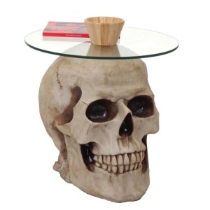 MCW Beistelltisch Totenkopf A19: Wohnzimmertisch mit Glasplatte auf Totenkopf-Fuß.