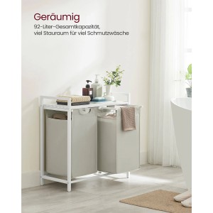 Weißer Vasagle Wäschekorb mit 2 Fächern (92 l) und Ablage im Badezimmer.