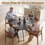 Runder schwarzer Esstisch mit Holzoptik und X-Beinen aus Stahl, an dem eine Familie isst. Platz für 4 Personen.