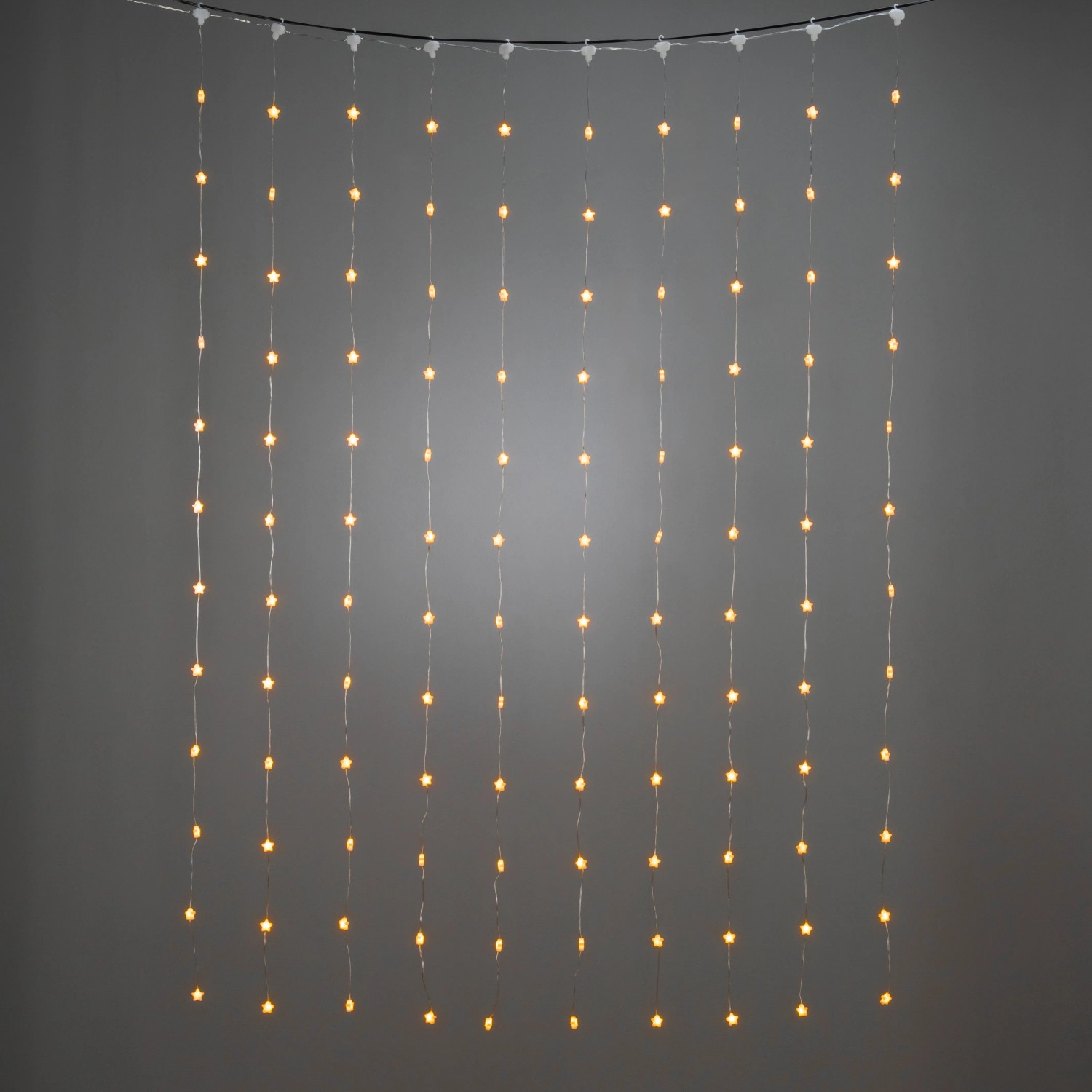 Konstsmide LED-Lichtervorhang mit 120 bernsteinfarbenen Sternen für Innen, transparentes Kabel.