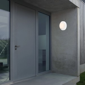 Weiße Brilo Akku Außenwandleuchte Pula mit Bewegungsmelder an Hauswand.