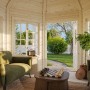 Innenansicht Palmako Holz-Pavillon Veronica 4: Unbehandelte Gartenlaube mit Möbeln und Blick in den Garten.