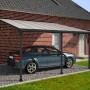 Palram Canopia Terrassenüberdachung Feria Anthrazit 4x4.2 mit Auto vor Backsteinhaus.