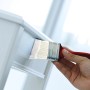Hand lackiert mit Pinsel aus dem 6-teiligen Pinsel-Set einen weißen Tisch.