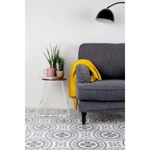 Wohnraum mit Kreide-Bodenfarbe in Kalkweiß von Rust-Oleum. Gemusterter Boden, graues Sofa, gelbe Decke.