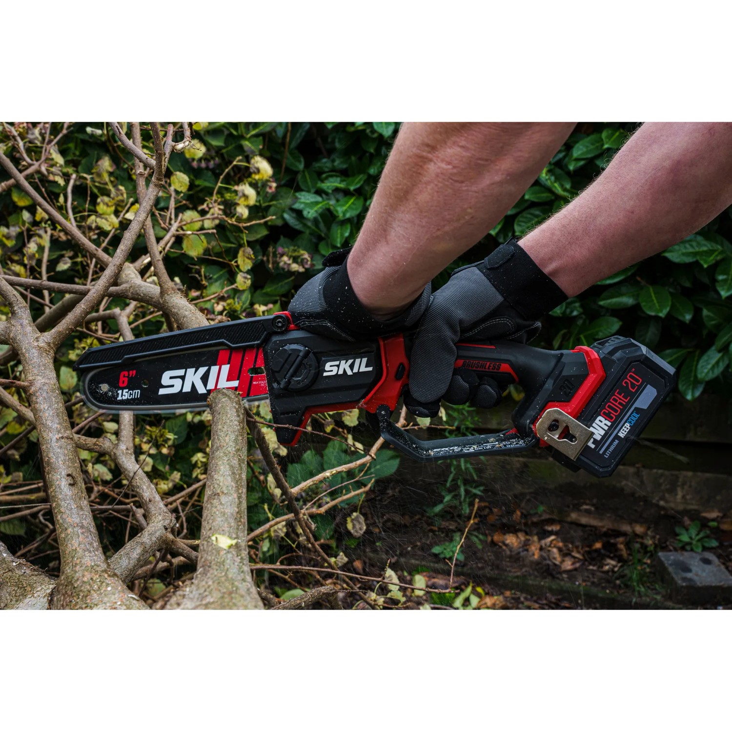 Skil Akku-Ästsäge 0512CA mit 15 cm Schwertlänge im Einsatz beim Schneiden von Ästen.