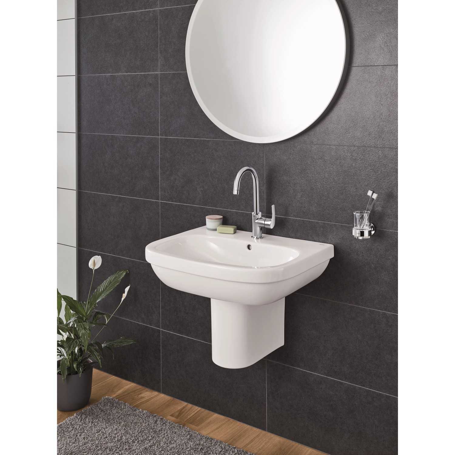 Grohe Euro Keramik Waschbecken, 65 cm, Alpinweiß mit Armatur und Spiegel vor dunkler Wand.