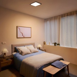Philips Valen LED-Deckenleuchte, schwarz, 40 cm, in modernem Schlafzimmer. WarmGlow Licht für gemütliche Atmosphäre.