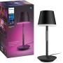 Schwarze Philips Hue Go Tischleuchte mit Farbwiedergabe und Verpackung.