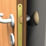 Detailaufnahme einer Holztür mit Türbeschlag und Griff.