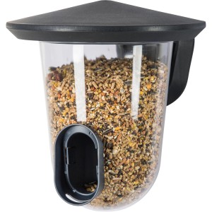 SingingFriend Vogelfutter-Spender Feedr Grey, gefüllt mit Vogelfutter.