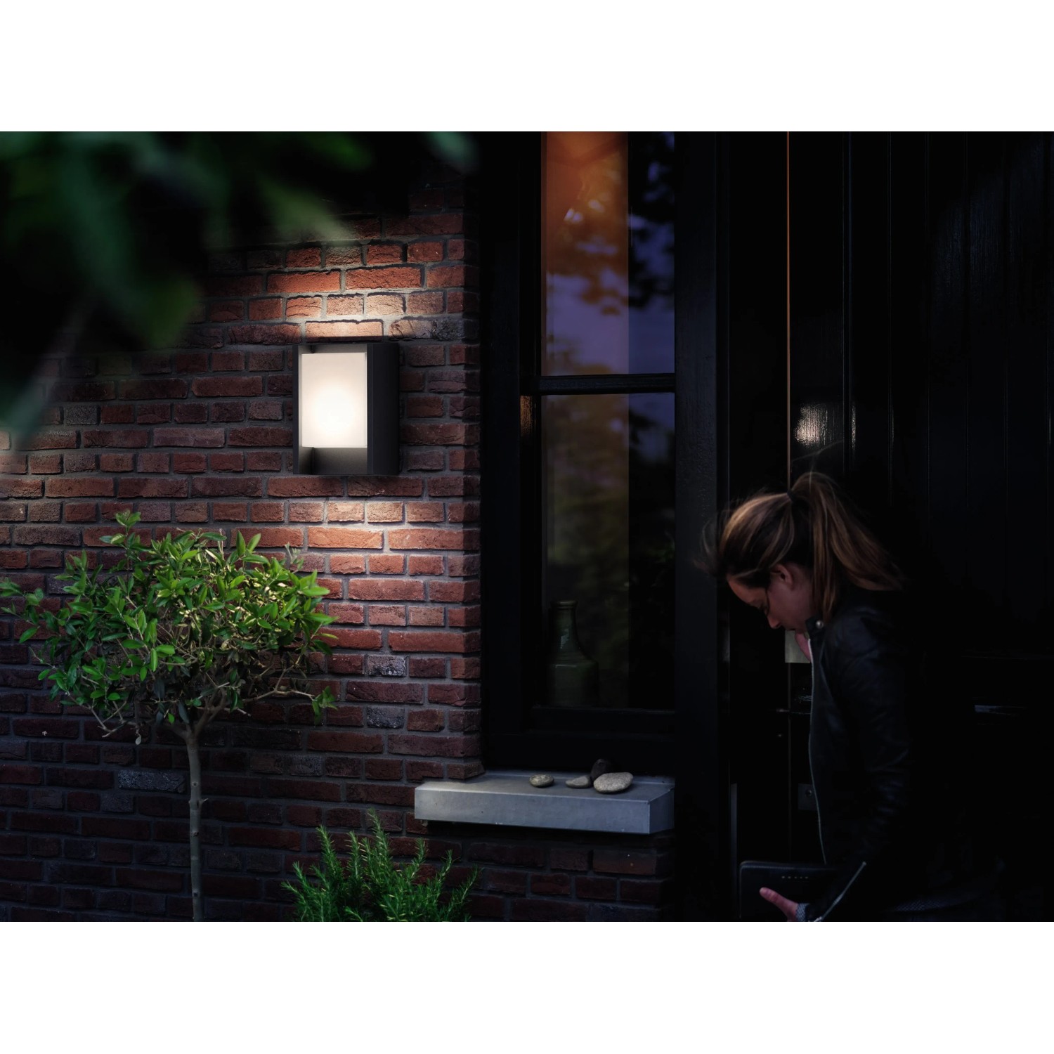 Anthrazitfarbene LED-Wandleuchte Arbour Ultra-Efficient an einer Backsteinmauer.