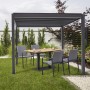 Best Terrassenüberdachung Cadiz 360x530 cm mit Lamellendach und Sitzgruppe im Garten.