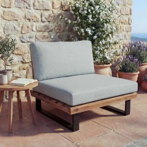 Heller Lounge-Sessel H54 mit hellgrauen Polstern und Akazienholz-Gestell im Garten.